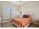 Comfortable bedroom with natural light from two arched windows and tile flooring at 3050 Rivershore Ln, Port Charlotte, FL 33953