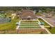 A clubhouse showing a bocce ball court with a lovely green lawn area and building facade at 3050 Rivershore Ln, Port Charlotte, FL 33953