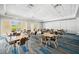 Large conference room with multiple tables, comfortable seating, and natural light from sliding glass doors at 3050 Rivershore Ln, Port Charlotte, FL 33953