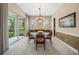 Elegant dining room with a chandelier, sliding glass doors to the patio, and views of the garden at 3050 Rivershore Ln, Port Charlotte, FL 33953