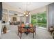 Charming dining area with a glass-top table, stylish seating, and views of the lush backyard at 3050 Rivershore Ln, Port Charlotte, FL 33953