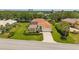 Charming single-Gathering home boasts lush landscaping, a brick-paved driveway, and a well-manicured lawn at 3050 Rivershore Ln, Port Charlotte, FL 33953
