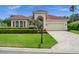 Charming single-story home with a red tile roof, manicured lawn, and beautiful landscaping at 3050 Rivershore Ln, Port Charlotte, FL 33953