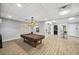 Game room with a covered pool table, decorative lighting, and easy access to adjacent rooms at 3050 Rivershore Ln, Port Charlotte, FL 33953