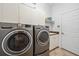 Laundry room equipped with washer, dryer, and storage cabinets at 3050 Rivershore Ln, Port Charlotte, FL 33953