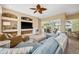 Open-concept living room offering a comfortable space for relaxation with views of the outdoor pool at 3050 Rivershore Ln, Port Charlotte, FL 33953