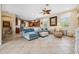 Open living area with cozy seating, tile floors, and access to the dining area and kitchen at 3050 Rivershore Ln, Port Charlotte, FL 33953