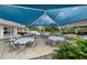 Outdoor event space featuring a large shade structure, tables, chairs, and picturesque landscaping at 3050 Rivershore Ln, Port Charlotte, FL 33953