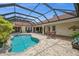 Serene pool and patio area with a screened enclosure, hot tub, and ample seating at 3050 Rivershore Ln, Port Charlotte, FL 33953