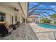 Relaxing screened-in pool area with cozy seating and a beautiful outdoor setting at 3050 Rivershore Ln, Port Charlotte, FL 33953