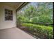 Relaxing screened porch provides a peaceful outdoor retreat surrounded by lush landscaping at 3050 Rivershore Ln, Port Charlotte, FL 33953