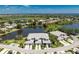 Expansive aerial view showcasing condos with water views, mature trees, and pristine landscaping at 3412 Grand Vista Ct # 202, Port Charlotte, FL 33953