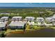 Aerial view showing condo building with lake view, green landscaping, and beautiful community setting at 3412 Grand Vista Ct # 202, Port Charlotte, FL 33953