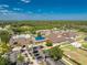 Bird's-eye view of the community pool, clubhouse, and well-kept grounds showcasing luxury amenities at 3412 Grand Vista Ct # 202, Port Charlotte, FL 33953