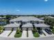 This aerial shot showcases condos with lush surroundings, a waterfront view, and attached garages at 3412 Grand Vista Ct # 202, Port Charlotte, FL 33953