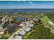 Panoramic view of multi-Gathering home nestled in a community with landscaping and views of a lake and golf course at 3412 Grand Vista Ct # 202, Port Charlotte, FL 33953
