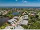 Aerial view of multi-Gathering residence with mature landscaping and views of a lake and golf course at 3412 Grand Vista Ct # 202, Port Charlotte, FL 33953