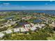 Breathtaking aerial perspective with lake views highlighting a multi-Gathering home near a golf course at 3412 Grand Vista Ct # 202, Port Charlotte, FL 33953
