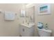Bathroom featuring a large mirror, neutral walls, and white fixtures at 3412 Grand Vista Ct # 202, Port Charlotte, FL 33953