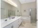 Bright bathroom featuring double sinks, a tub, and a separate shower at 3412 Grand Vista Ct # 202, Port Charlotte, FL 33953
