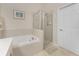 Bathroom featuring soaking tub and glass enclosed shower at 3412 Grand Vista Ct # 202, Port Charlotte, FL 33953