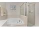 Bathroom featuring soaking tub and glass enclosed shower at 3412 Grand Vista Ct # 202, Port Charlotte, FL 33953