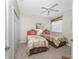 Charming bedroom featuring two twin beds, ceiling fan, and neutral walls at 3412 Grand Vista Ct # 202, Port Charlotte, FL 33953