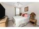 Comfortable bedroom features a ceiling fan, lamps, and a window letting in natural light at 3412 Grand Vista Ct # 202, Port Charlotte, FL 33953
