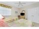 Cozy bedroom with twin beds, a window letting in natural light, and a dresser with a television at 3412 Grand Vista Ct # 202, Port Charlotte, FL 33953