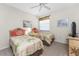 Comfortable bedroom featuring two twin beds with floral bedding, complemented by light walls and a ceiling fan at 3412 Grand Vista Ct # 202, Port Charlotte, FL 33953