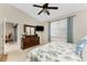 Bright bedroom features a high ceiling, large dresser with mirror, and a view into the living area at 3412 Grand Vista Ct # 202, Port Charlotte, FL 33953