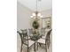 Elegant dining room with glass table, chandelier, and decorative mirror, perfect for hosting gatherings at 3412 Grand Vista Ct # 202, Port Charlotte, FL 33953