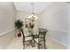 Formal dining room with decorative chandelier, glass table, and tile floors, great for entertaining at 3412 Grand Vista Ct # 202, Port Charlotte, FL 33953
