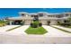 Well-maintained townhome exterior featuring a two-car garage, tidy landscaping, and a paved driveway at 3412 Grand Vista Ct # 202, Port Charlotte, FL 33953