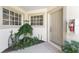 Charming front entry features a neutral door and lovely landscaping, creating a warm welcome at 3412 Grand Vista Ct # 202, Port Charlotte, FL 33953