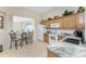 Kitchen offers white appliances, wood cabinets, a pass-through window and a breakfast nook for additional seating at 3412 Grand Vista Ct # 202, Port Charlotte, FL 33953