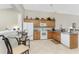 Kitchen offers white appliances, wood cabinets, a pass-through window and a breakfast nook for additional seating at 3412 Grand Vista Ct # 202, Port Charlotte, FL 33953
