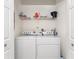 Neat laundry room with washer and dryer and shelving at 3412 Grand Vista Ct # 202, Port Charlotte, FL 33953