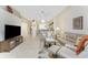 Spacious living room featuring neutral walls, tile floors, ceiling fan, and comfortable seating arrangement at 3412 Grand Vista Ct # 202, Port Charlotte, FL 33953