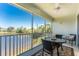 Relaxing screened patio with seating offers a beautiful view of the lake at 3412 Grand Vista Ct # 202, Port Charlotte, FL 33953