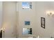 Bright and airy staircase showcasing tall ceilings, large windows, and decorative wall art at 3412 Grand Vista Ct # 202, Port Charlotte, FL 33953