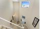High ceiling staircase with large windows lets in plenty of natural light with decorative wall art at 3412 Grand Vista Ct # 202, Port Charlotte, FL 33953