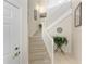 Carpeted staircase with white railing, features a landing with neutral tile floors and decor at 3412 Grand Vista Ct # 202, Port Charlotte, FL 33953