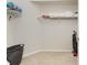 Spacious walk-in closet with shelving for organized storage at 3412 Grand Vista Ct # 202, Port Charlotte, FL 33953