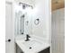 Bathroom featuring sleek vanity, black faucet, and modern lighting fixture at 3502 N Lincoln Ave, Tampa, FL 33607