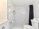 Stylish bathroom features marble-look tiled walls, a modern shower with a black curtain, and updated fixtures for a clean design at 3502 N Lincoln Ave, Tampa, FL 33607