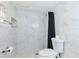 Modern bathroom features stylish marble-look tiles, an updated shower, and clean fixtures for a relaxing and luxurious space at 3502 N Lincoln Ave, Tampa, FL 33607