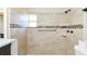 Close-up of bathroom shower with stylish tile, window, and accessible handrail at 3502 N Lincoln Ave, Tampa, FL 33607