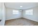 Bright bedroom featuring wood flooring, two windows, and a mini-split A/C unit at 3502 N Lincoln Ave, Tampa, FL 33607