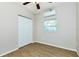 Clean bedroom boasts sleek flooring, a ceiling fan, and a double door closet, maximizing space and style at 3502 N Lincoln Ave, Tampa, FL 33607